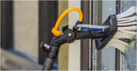 Window cleaning brush on window