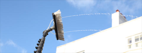 Window Cleaning brush spraying purified water